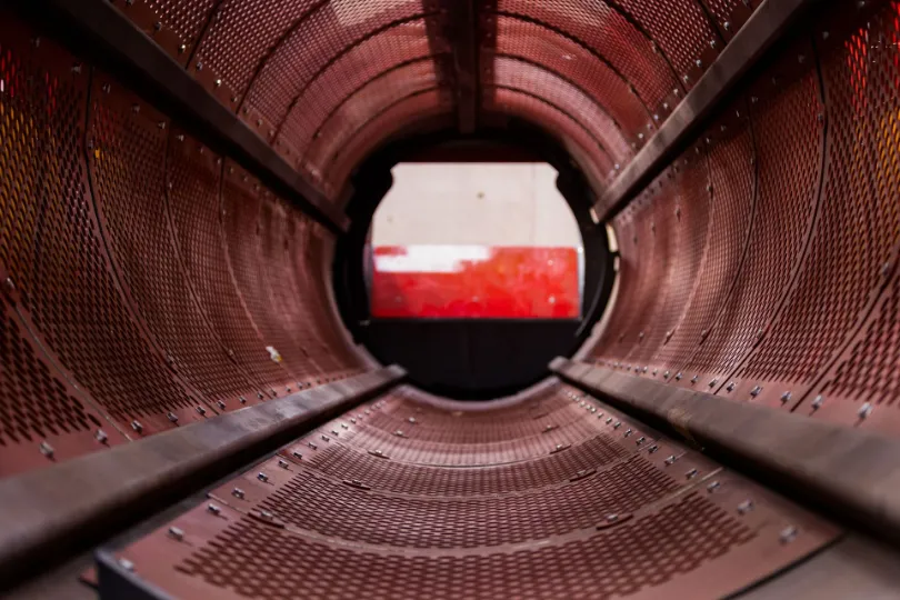 Inside industrial metal drum cylinder tunnel view