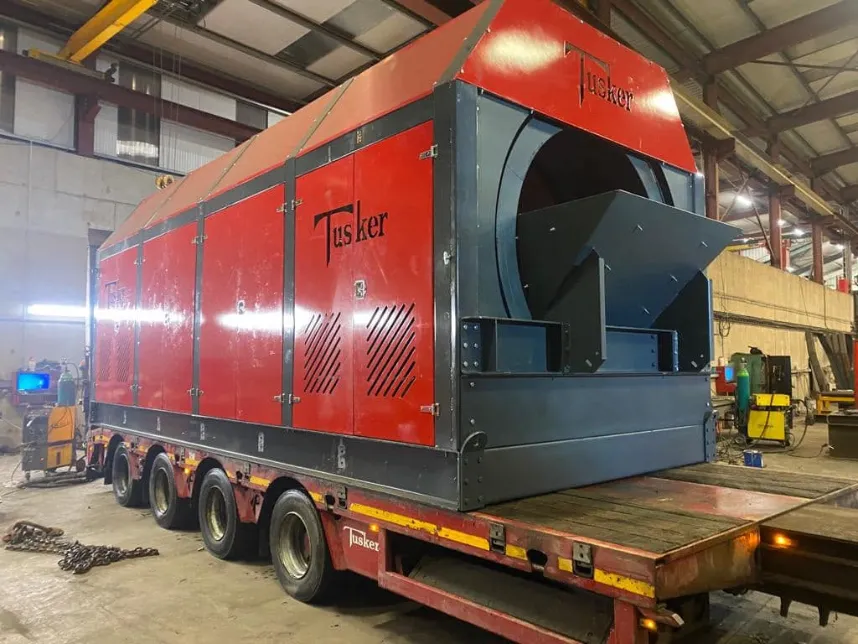 Tusker recycling equipment loaded on flatbed in workshop