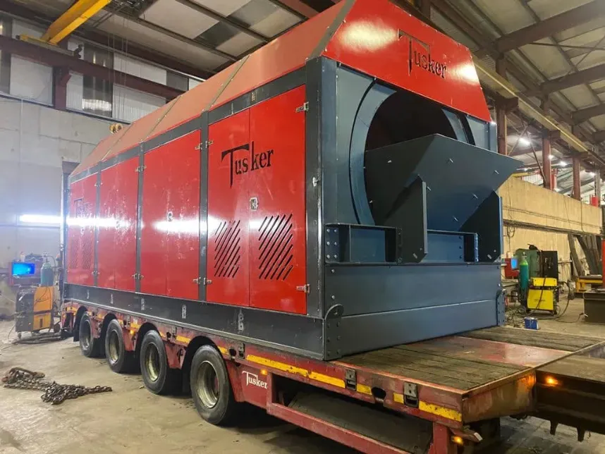 Tusker red industrial drum machine loaded on flatbed in warehouse