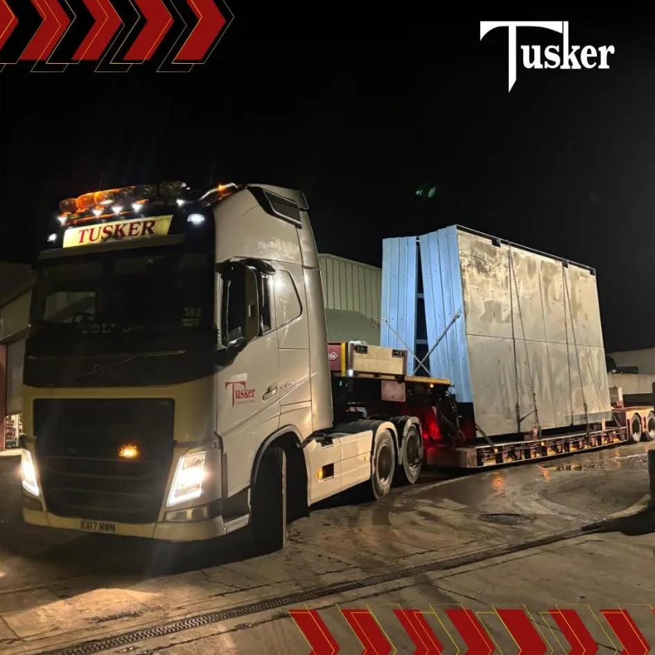 Tusker Volvo heavy haulage truck transporting oversized load at night