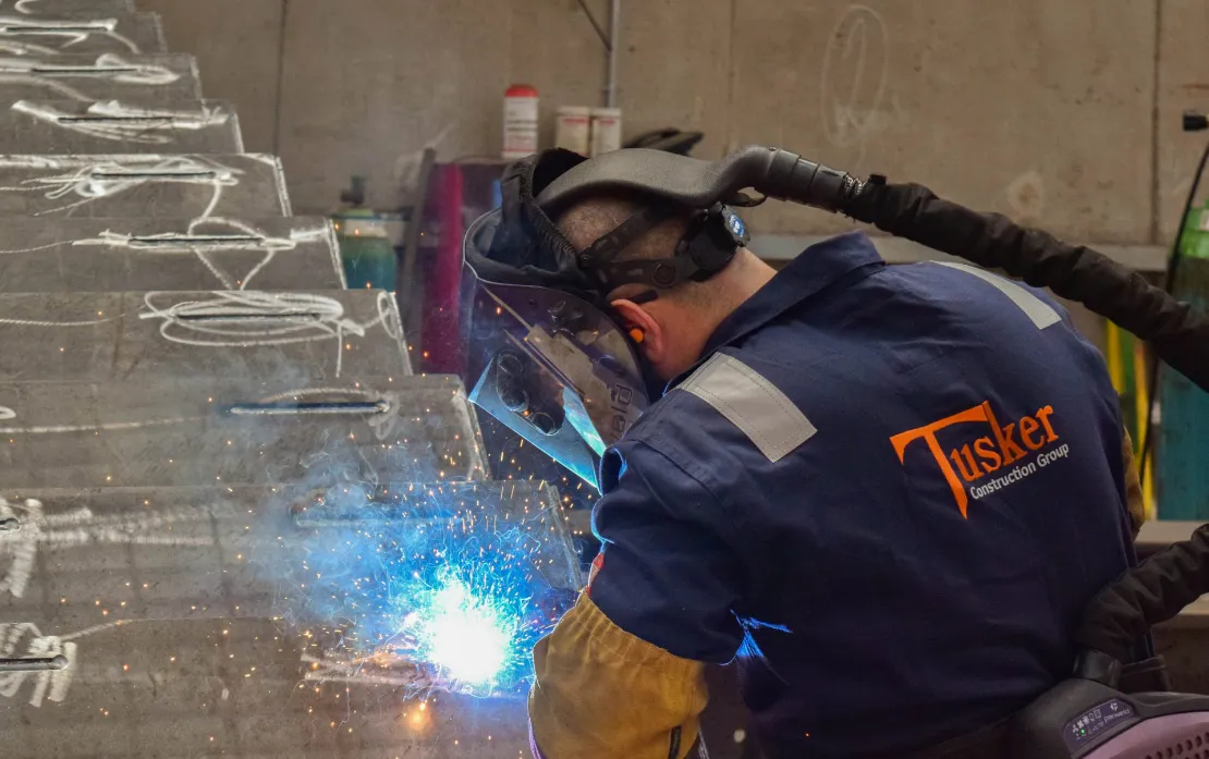 Tusker welder working on structural steel fabrication
